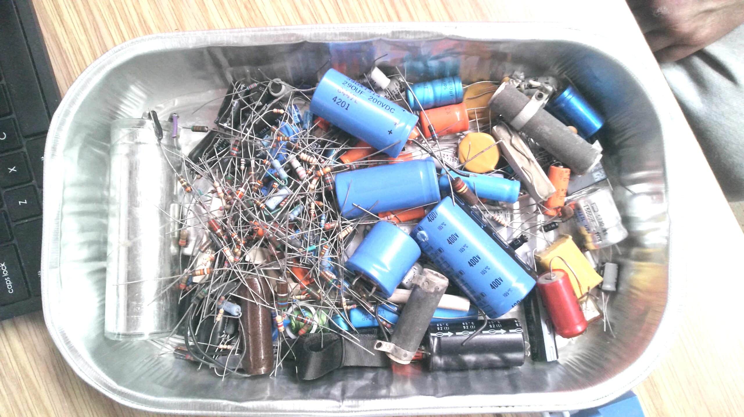 Box of assorted capacitors/resistors/cables etc. –